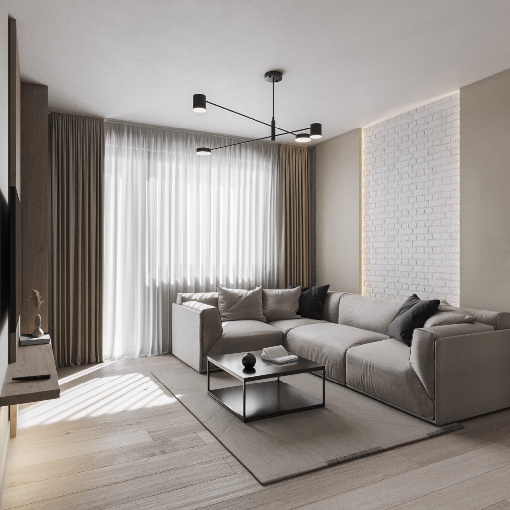 Living cu canapea gri de colț, lustră neagră cu brațe și perete din cărămidă albă, apartament de 52 mp